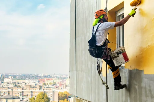 Rope-access painter on a tall condo building near King Harbor